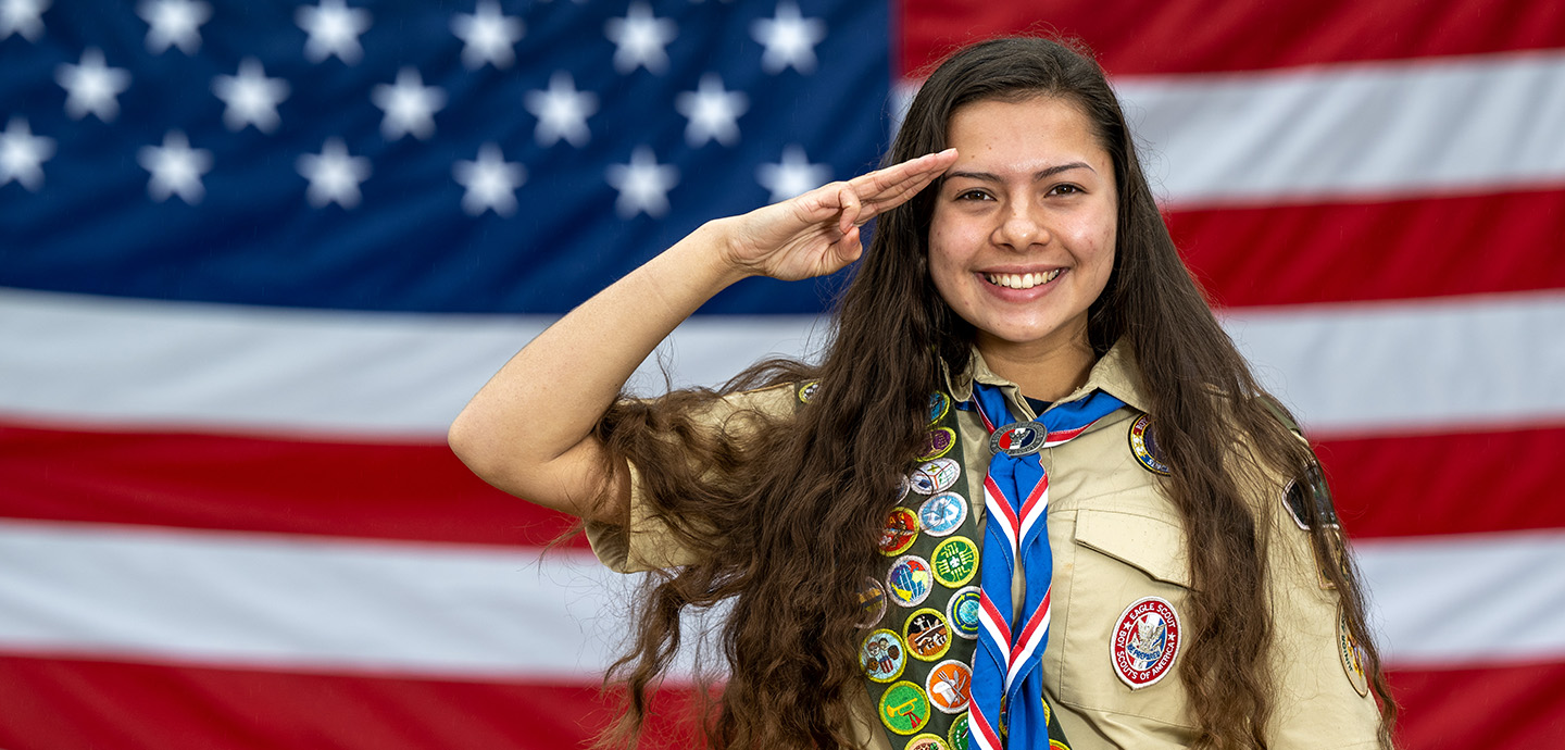 Boyscout saluting with the American Flag